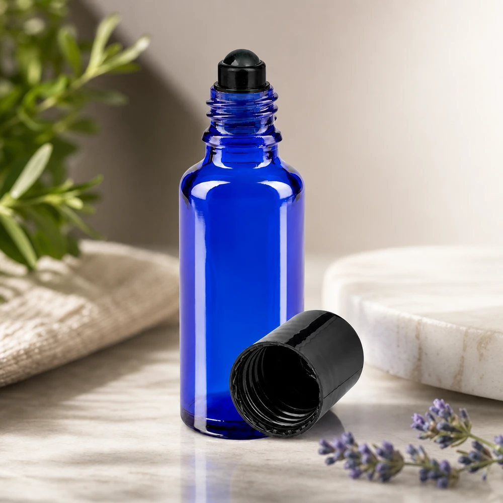 Blauwe roll-onfles STD van 30 ml voor etherische oliën, met een zwarte bal en kruidendecoratie