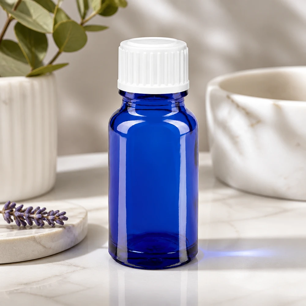 Donkerblauw apothekersflesje van 10 ml met een witte schroefdop van 11 mm voor aromatherapie