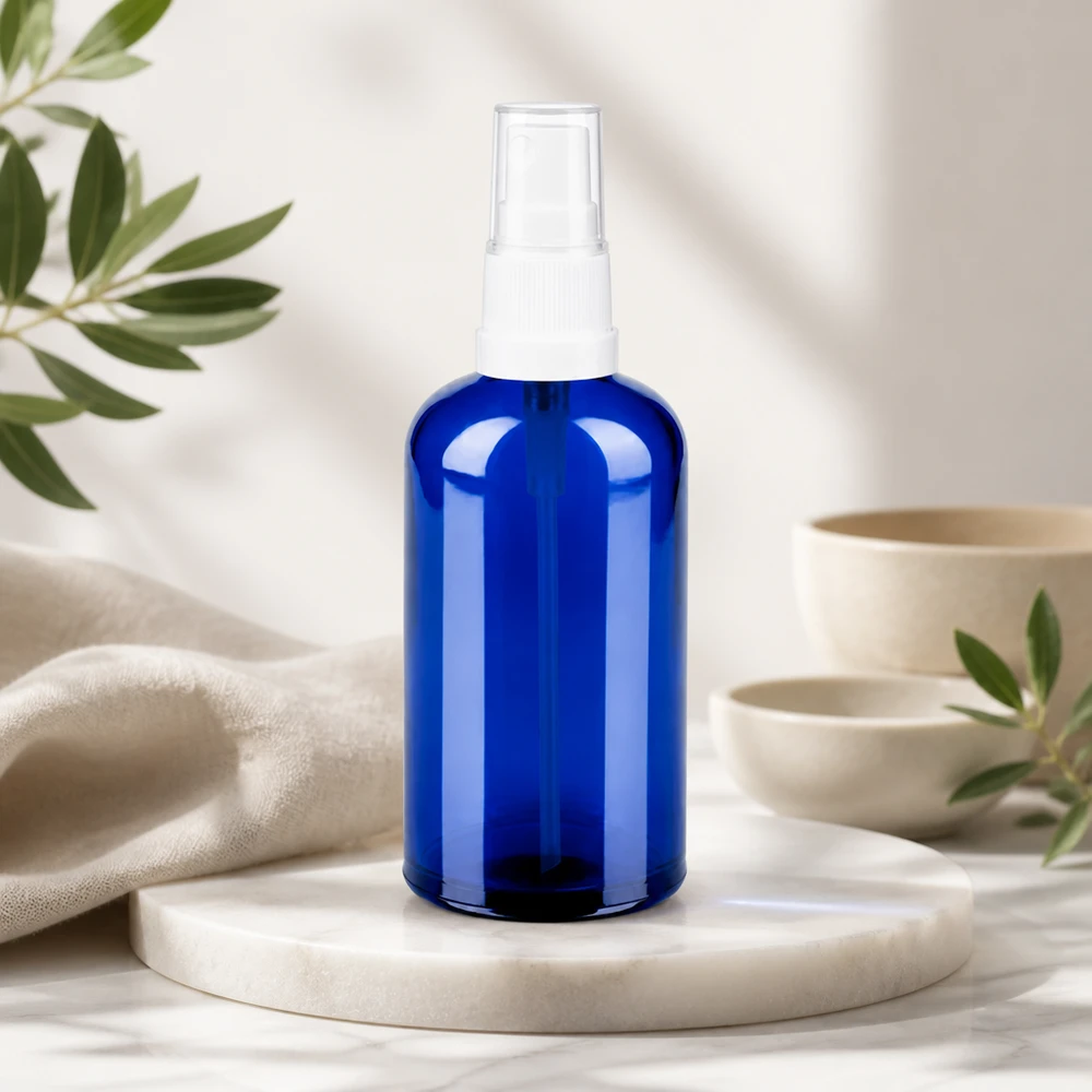 Hoogwaardige 100ml sprayflacon van blauw glas met transparant design voor natuurlijke verzorging