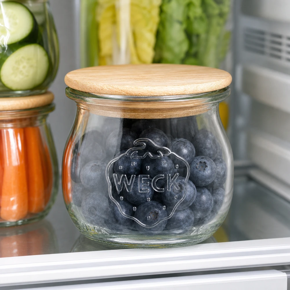 WECK-tulpglas 75ml met deksel WECK tulpenpot RR40 75ml met houten deksel gevuld met blauwe bessen in de koelkast naast andere voorraadpotten