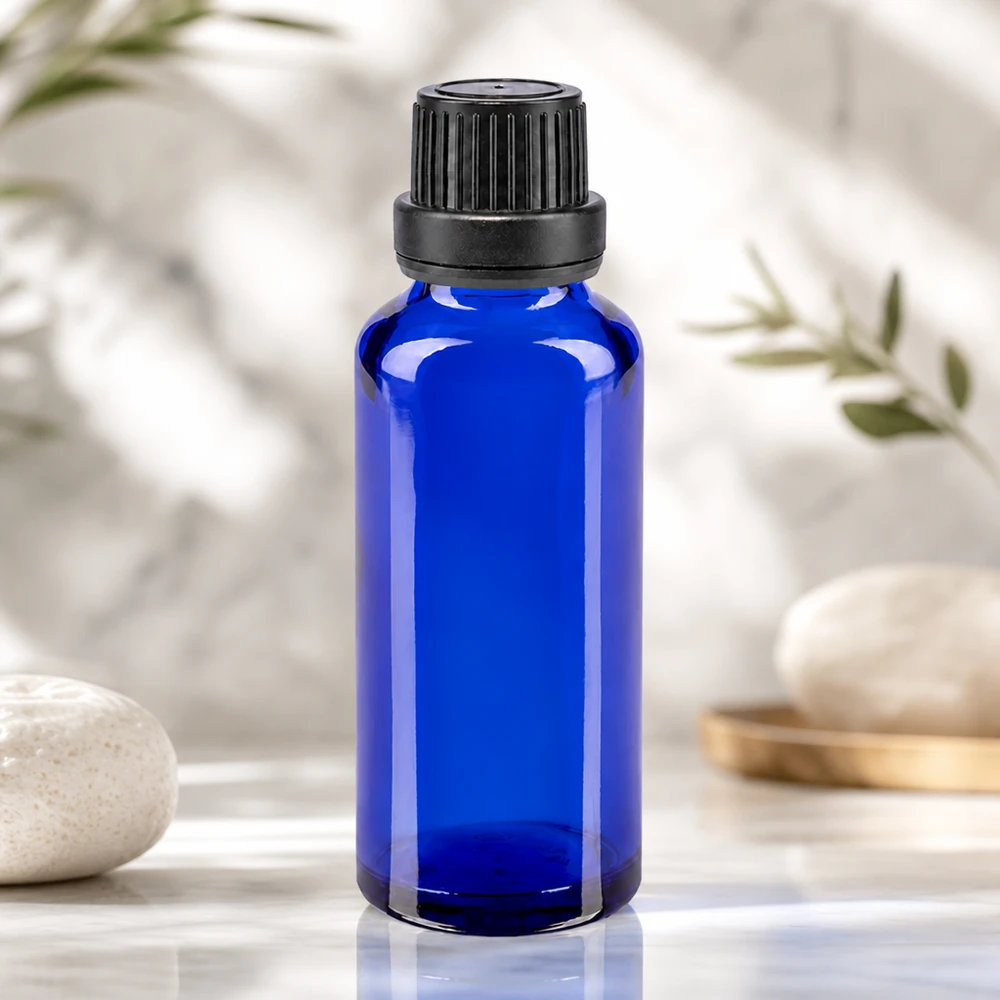 Blauwe glazen flessen 30ml met zwart schroefsluiting dicht. VR Premium Cilindrische blauwe apothekersglasfles van 30 ml met een geribbelde schroefdop, zwarte hals van 11 mm